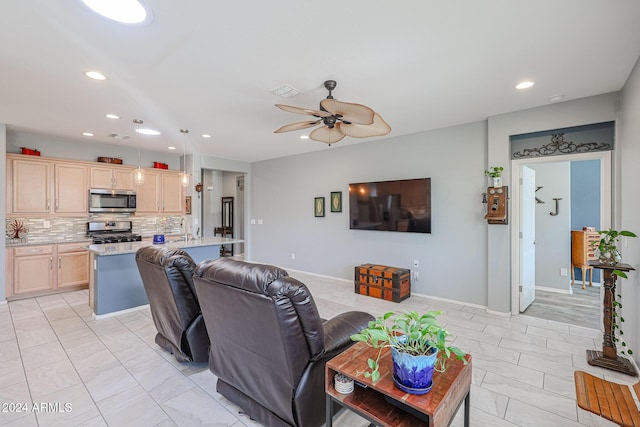 living room with ceiling fan and sink