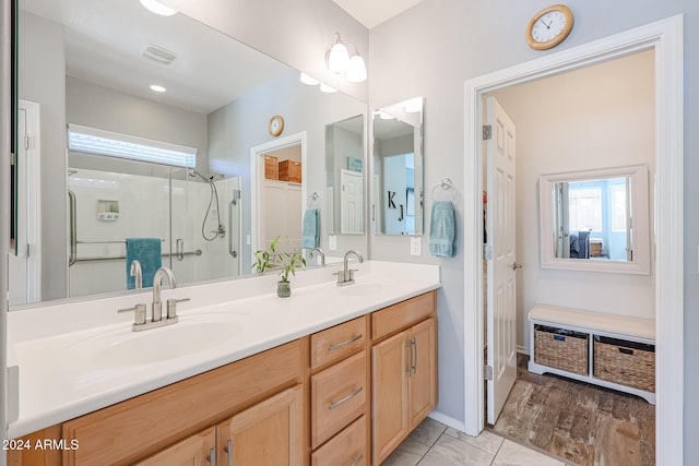 bathroom featuring tile patterned flooring, vanity, and an enclosed shower