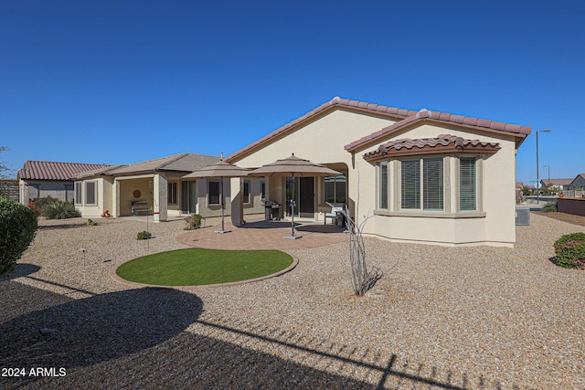 rear view of house featuring a patio