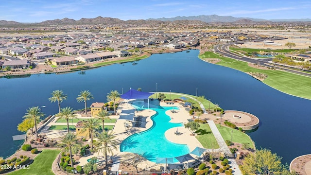 drone / aerial view with a water and mountain view