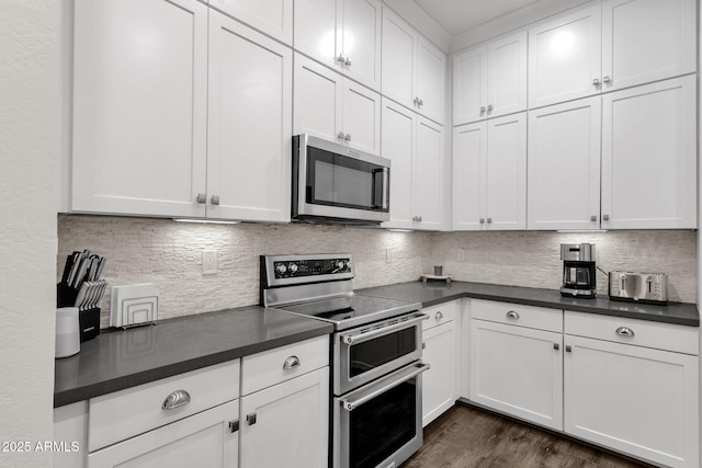 6565 E Thomas Rd Unit 1096, Scottsdale, AZ 85251 - kitchen with stainless steel appliances, dark countertops, and white cabinetry