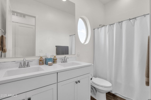 6565 E Thomas Rd Unit 1096, Scottsdale, AZ 85251 - full bathroom with double vanity, toilet, and wood finished floors