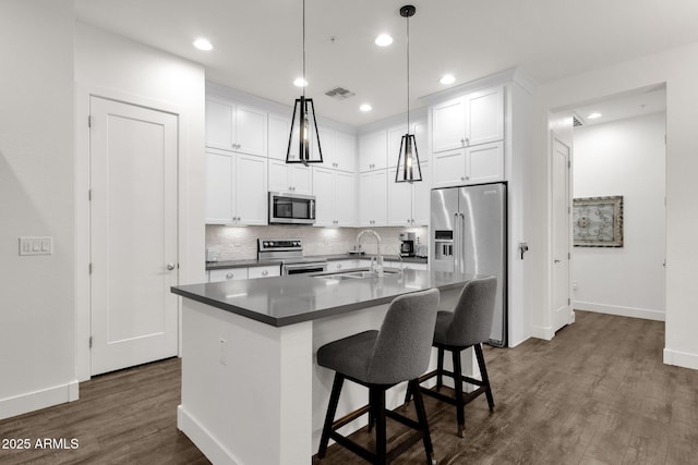 6565 E Thomas Rd Unit 1096, Scottsdale, AZ 85251 - kitchen with a sink, appliances with stainless steel finishes, baseboards, dark wood-type flooring, and recessed lighting
