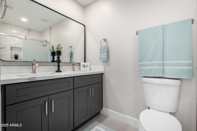 bathroom with toilet, a shower with shower door, and vanity