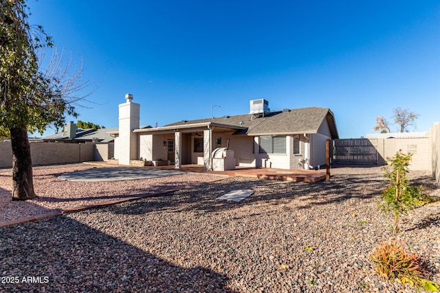 rear view of house with central air condition unit and a patio area