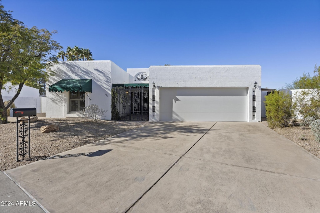 pueblo revival-style home with a garage