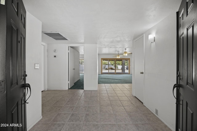 tiled foyer with ceiling fan