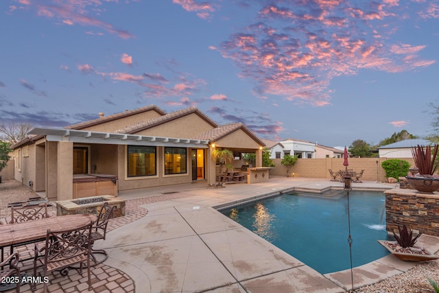 view of swimming pool featuring outdoor dry bar, a hot tub, fence, a fenced in pool, and a patio area