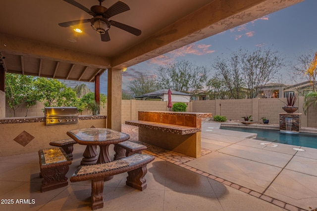 patio terrace at dusk featuring grilling area, a fenced in pool, a fenced backyard, area for grilling, and a ceiling fan