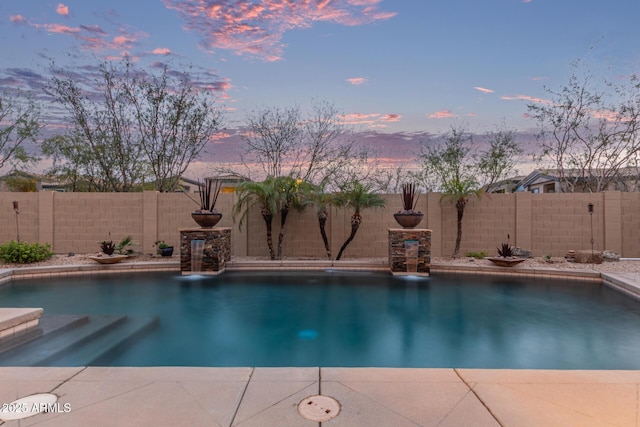 pool at dusk with a fenced in pool, a fenced backyard, and a patio area