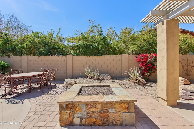 view of patio featuring outdoor dining space, a fenced backyard, and a pergola