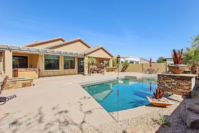 view of pool featuring a patio area, a jacuzzi, a fenced backyard, and a fenced in pool