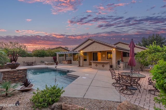 view of swimming pool with a fenced in pool, fence, outdoor dry bar, and a patio area