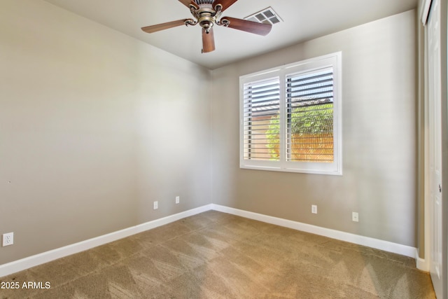 empty room with visible vents, baseboards, carpet, and ceiling fan