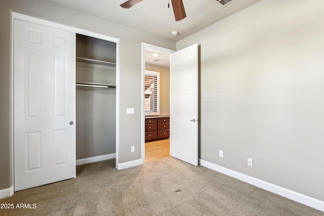 unfurnished bedroom with a closet, visible vents, baseboards, and carpet floors