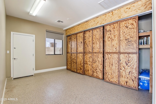 unfurnished bedroom with visible vents and baseboards