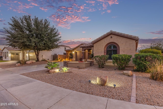 view of front of home featuring stucco siding and a tile roof