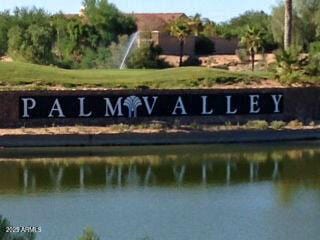 community / neighborhood sign with a water view