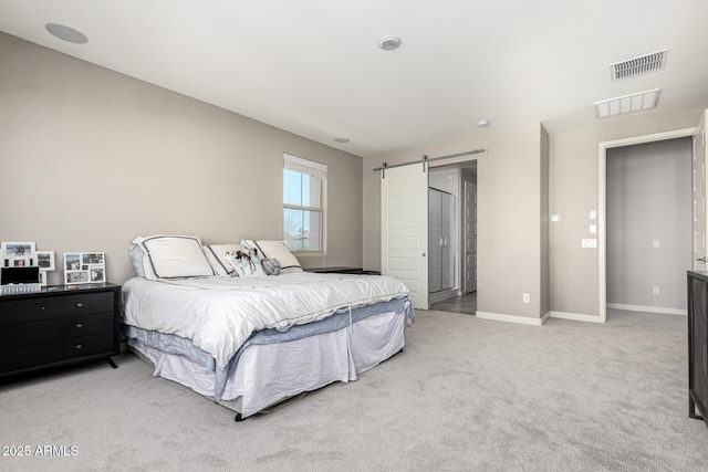 carpeted bedroom with a barn door