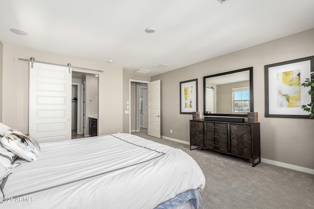 carpeted bedroom featuring a barn door