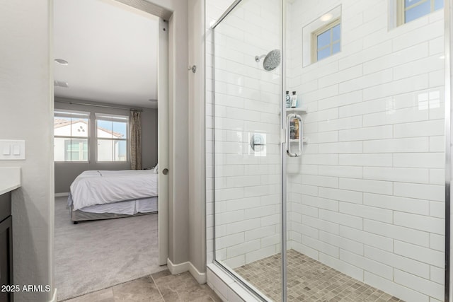 bathroom featuring tile patterned flooring, vanity, and a shower with shower door