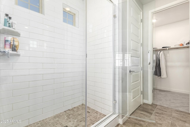 bathroom with a shower with door