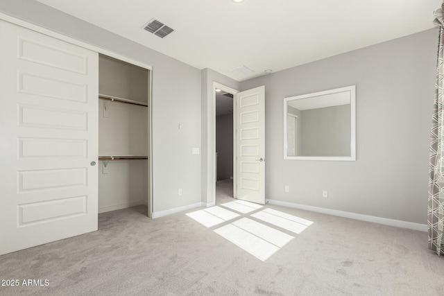 unfurnished bedroom featuring light carpet and a closet