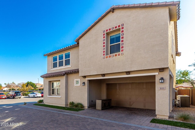 exterior space featuring central AC unit and a garage