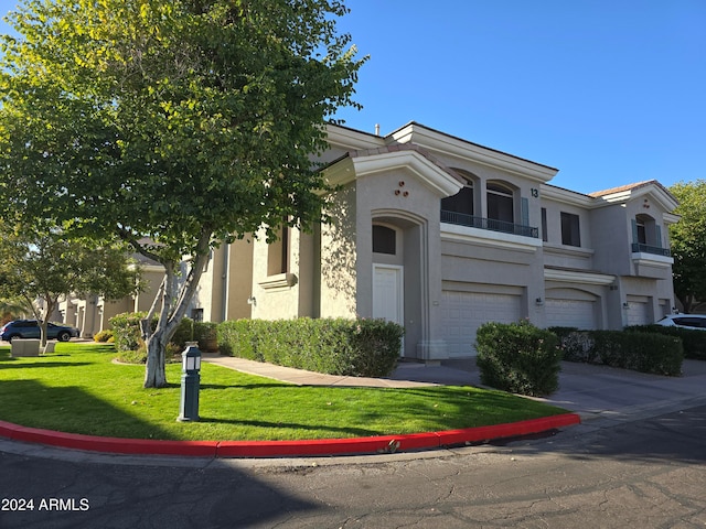 view of front of house with a garage and a front lawn