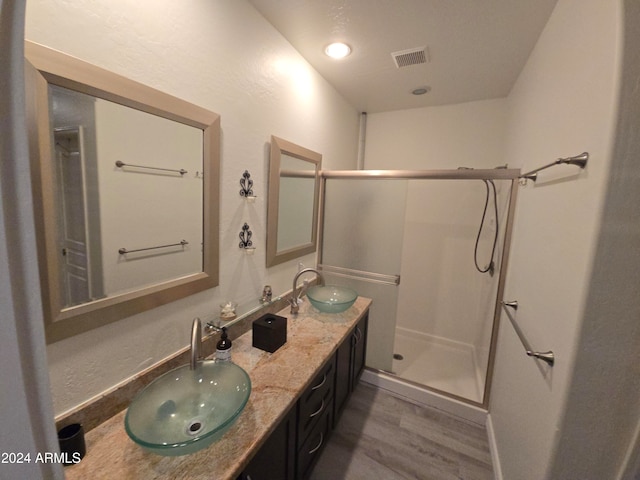 bathroom featuring vanity, an enclosed shower, and hardwood / wood-style flooring