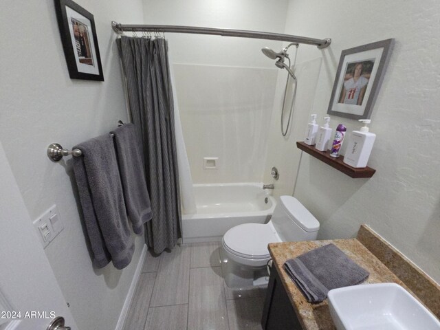 full bathroom with vanity, toilet, and shower / bath combo with shower curtain