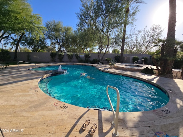 view of pool featuring an in ground hot tub and a patio area