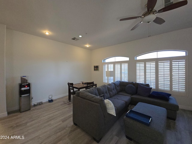 living room featuring ceiling fan and wood-type flooring