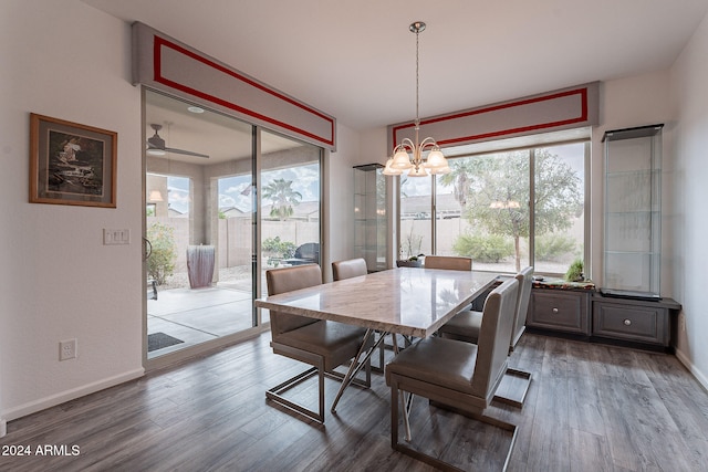 dining area with hardwood / wood-style flooring and ceiling fan with notable chandelier