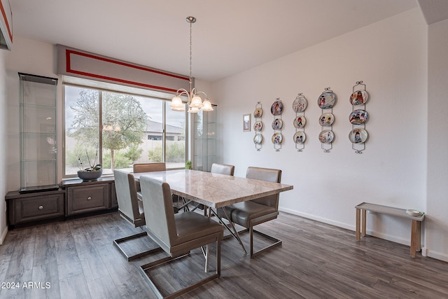 dining room featuring dark hardwood / wood-style floors and an inviting chandelier