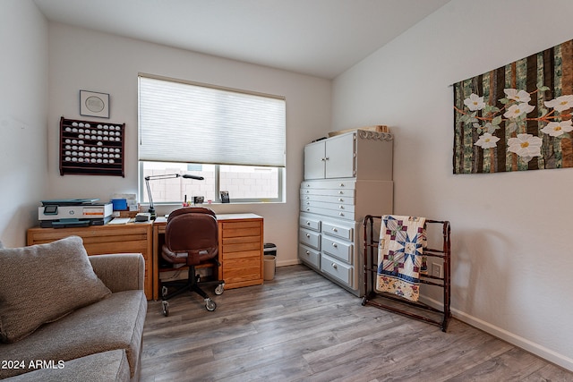 office featuring lofted ceiling and wood-type flooring