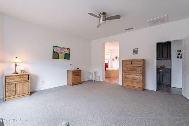 unfurnished bedroom featuring connected bathroom, ceiling fan, and carpet floors