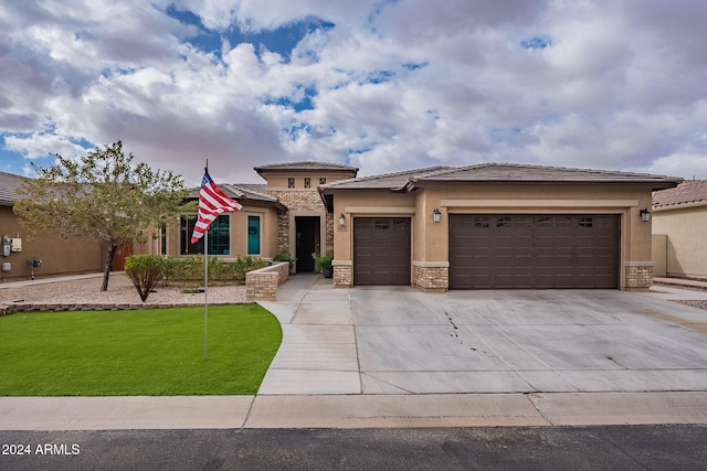 view of front of home with a front lawn and a garage