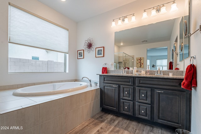 bathroom with vanity, hardwood / wood-style flooring, and separate shower and tub