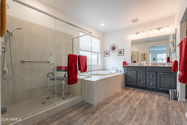 bathroom featuring vanity, separate shower and tub, and hardwood / wood-style flooring