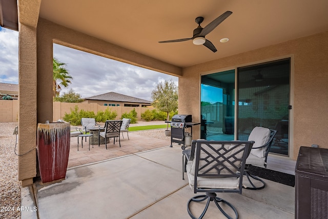 view of patio featuring area for grilling and ceiling fan