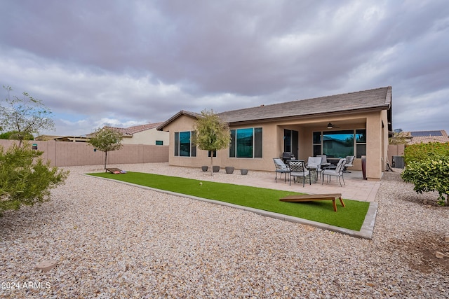 back of property with a patio, central AC unit, and ceiling fan