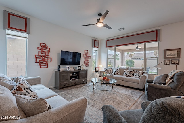 living room with light hardwood / wood-style floors and ceiling fan