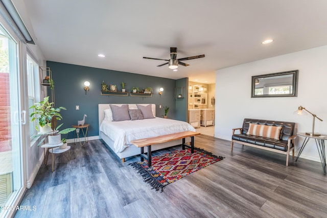 bedroom with wood-type flooring, ceiling fan, and ensuite bathroom