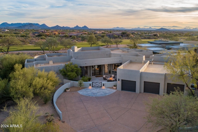 aerial view at dusk featuring a mountain view