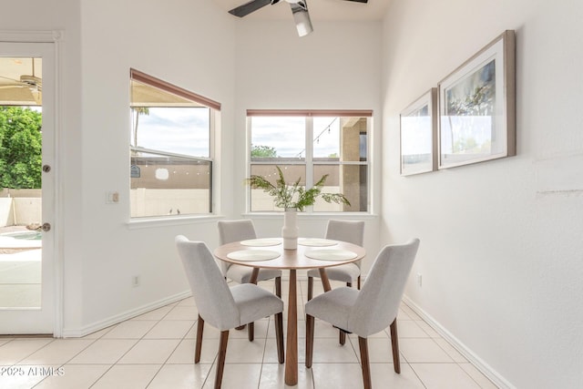 dining area with a ceiling fan, baseboards, and a wealth of natural light