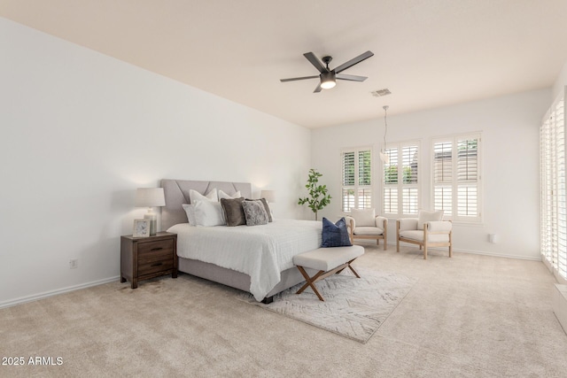 carpeted bedroom featuring a ceiling fan, baseboards, and visible vents
