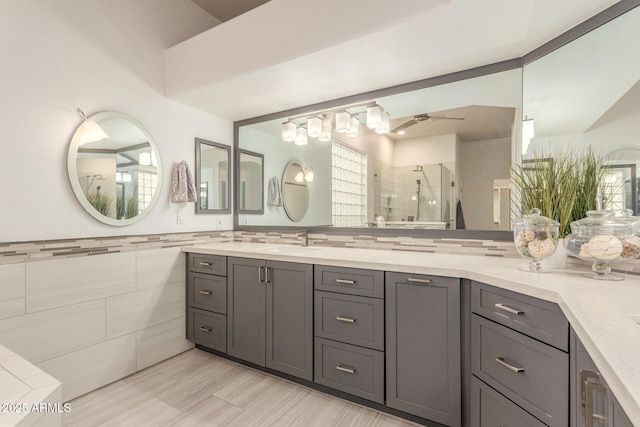 full bathroom with vanity, a ceiling fan, tile walls, and a stall shower