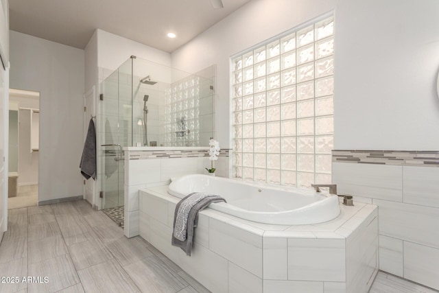 full bath featuring a garden tub and a stall shower