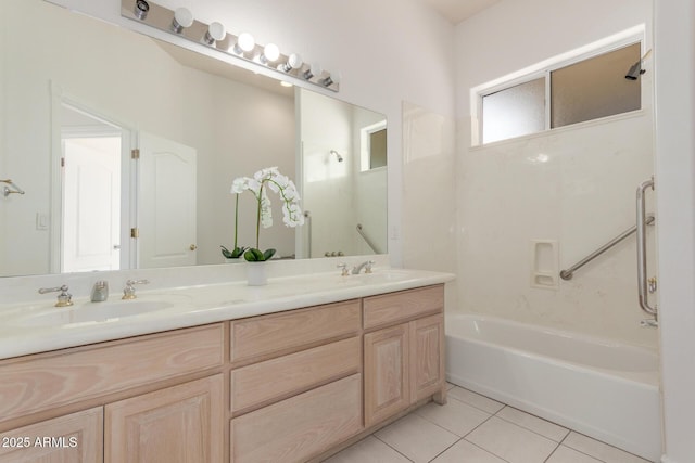 full bathroom with double vanity, a sink, tile patterned floors, and shower / washtub combination